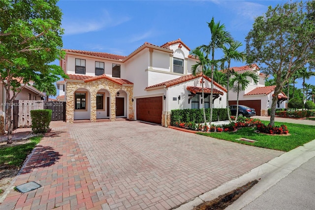 1007 NW 99th Ct, Miami, FL 33172 - mediterranean / spanish-style house with stucco siding, decorative driveway, a tile roof, and stone siding