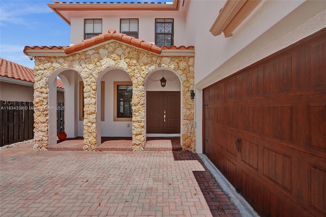 1007 NW 99th Ct, Miami, FL 33172 - entrance to property featuring stucco siding, a tiled roof, stone siding, and a porch