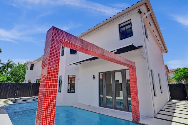 1007 NW 99th Ct, Miami, FL 33172 - back of house featuring stucco siding and french doors