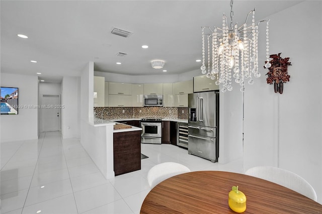 1007 NW 99th Ct, Miami, FL 33172 - kitchen with appliances with stainless steel finishes, beverage cooler, backsplash, recessed lighting, and a peninsula