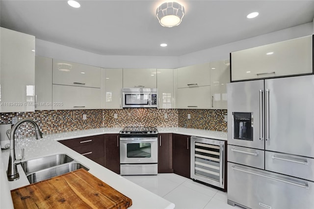1007 NW 99th Ct, Miami, FL 33172 - kitchen featuring appliances with stainless steel finishes, beverage cooler, light countertops, modern cabinets, and recessed lighting