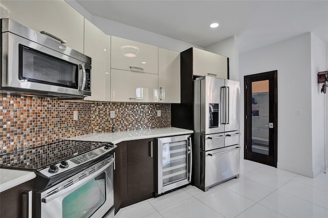 1007 NW 99th Ct, Miami, FL 33172 - kitchen with stainless steel appliances, beverage cooler, light countertops, backsplash, and light tile patterned floors