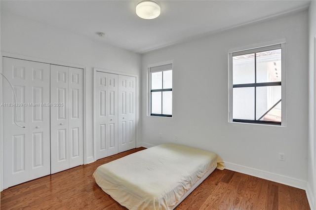 1007 NW 99th Ct, Miami, FL 33172 - bedroom with multiple closets and wood finished floors
