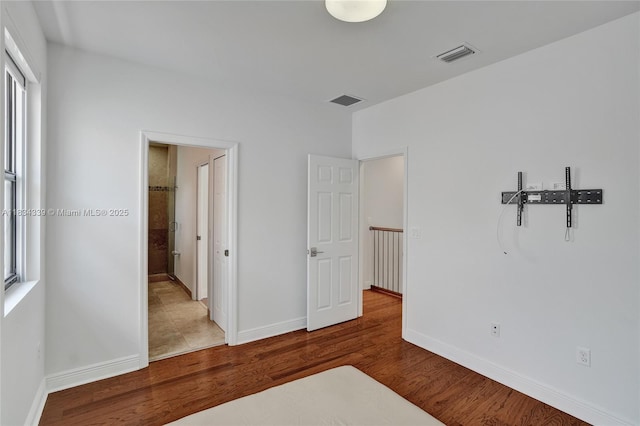 1007 NW 99th Ct, Miami, FL 33172 - unfurnished bedroom featuring wood finished floors and baseboards
