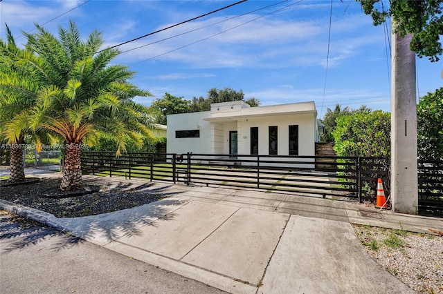 120 NW 41st St, Miami, FL 33127 - view of front of house with a gate, a fenced front yard, and stucco siding