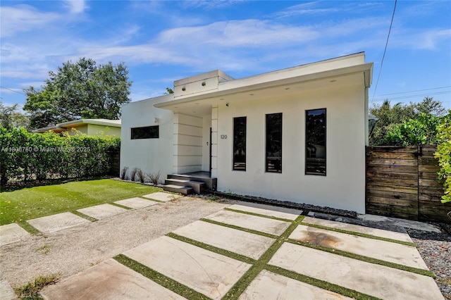 120 NW 41st St, Miami, FL 33127 - rear view of house featuring stucco siding and a patio