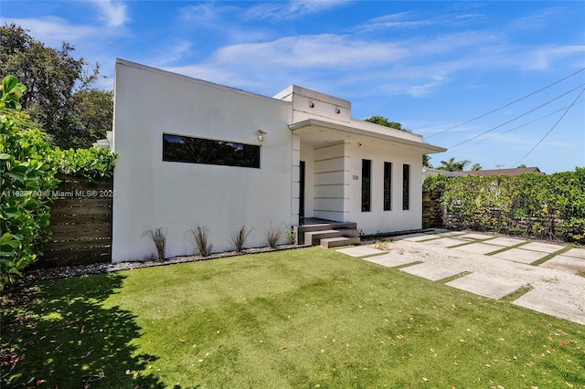 120 NW 41st St, Miami, FL 33127 - rear view of house featuring a lawn and stucco siding