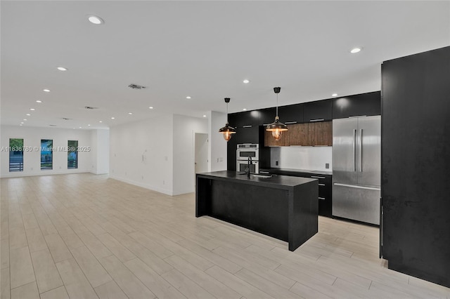 120 NW 41st St, Miami, FL 33127 - kitchen featuring stainless steel appliances, modern cabinets, dark countertops, recessed lighting, and decorative light fixtures