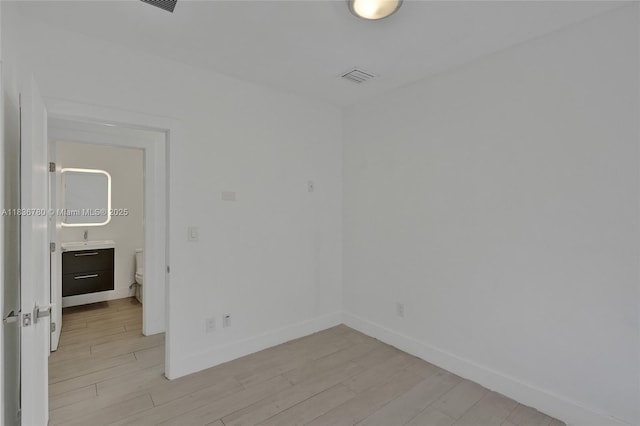 120 NW 41st St, Miami, FL 33127 - unfurnished room featuring light wood-type flooring and baseboards