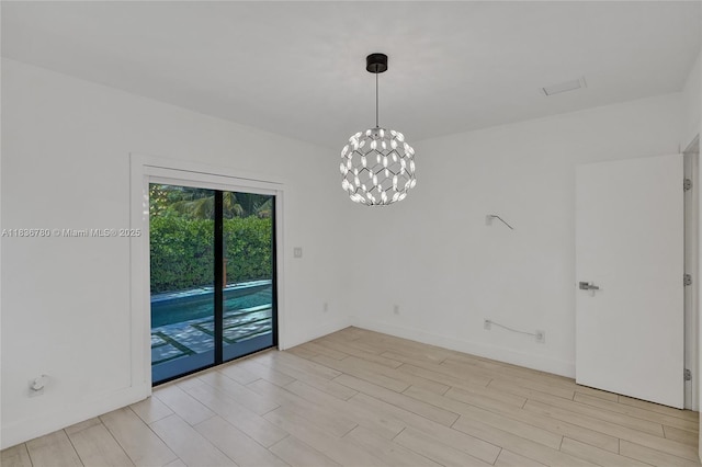 120 NW 41st St, Miami, FL 33127 - spare room with light wood-type flooring and a chandelier