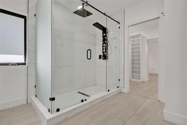 120 NW 41st St, Miami, FL 33127 - full bathroom with a marble finish shower, a walk in closet, and wood finished floors
