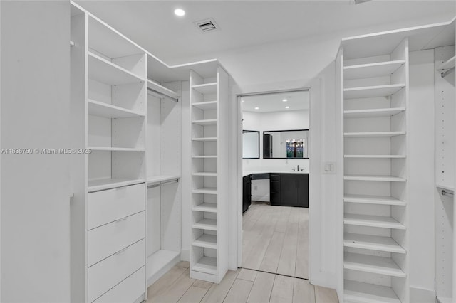 120 NW 41st St, Miami, FL 33127 - walk in closet featuring light wood finished floors and bar