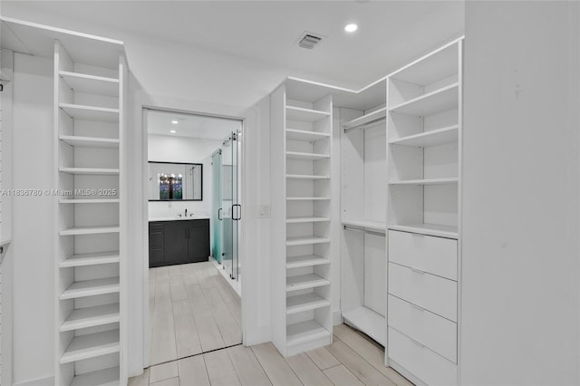 120 NW 41st St, Miami, FL 33127 - walk in closet with light wood-style flooring