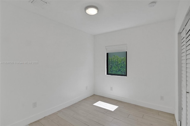 120 NW 41st St, Miami, FL 33127 - unfurnished bedroom with light wood finished floors