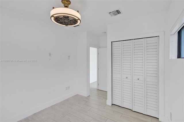 120 NW 41st St, Miami, FL 33127 - unfurnished bedroom featuring a closet and light wood-style floors