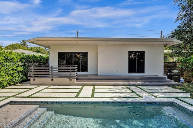 120 NW 41st St, Miami, FL 33127 - back of house with stucco siding, a patio, and an outdoor pool