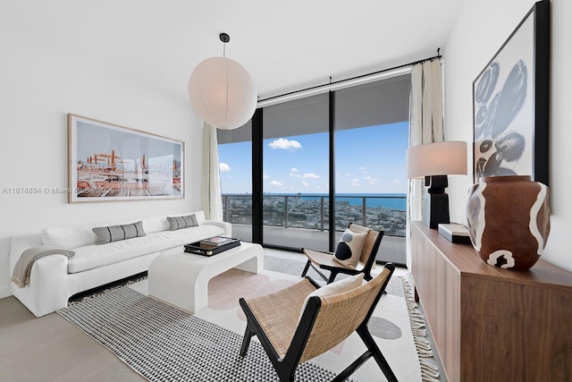500 Alton Rd Unit 4004, Miami Beach, FL 33139 - living room with expansive windows, light wood-style flooring, and a water view