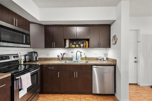 3660 N 56th Ave Unit 602, Hollywood, FL 33021 - kitchen with appliances with stainless steel finishes, dark brown cabinetry, light tile patterned floors, and open shelves