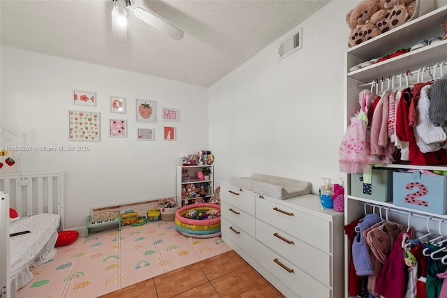 3660 N 56th Ave Unit 602, Hollywood, FL 33021 - bedroom featuring a textured ceiling, a ceiling fan, and light tile patterned floors