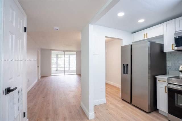 2780 N Pine Island Rd Unit 211, Sunrise, FL 33322 - kitchen featuring appliances with stainless steel finishes, white cabinets, light wood finished floors, light countertops, and recessed lighting