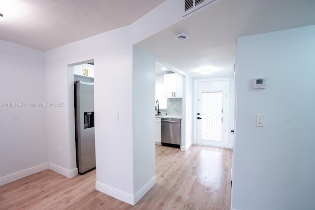 2780 N Pine Island Rd Unit 211, Sunrise, FL 33322 - hallway featuring light wood-style floors and a sink
