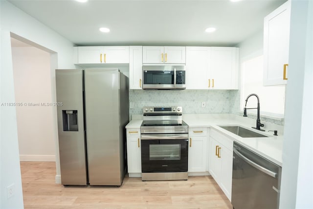 2780 N Pine Island Rd Unit 211, Sunrise, FL 33322 - kitchen featuring stainless steel appliances, white cabinetry, light countertops, recessed lighting, and light wood-style flooring