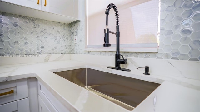 2780 N Pine Island Rd Unit 211, Sunrise, FL 33322 - kitchen with backsplash, white cabinets, and light stone counters