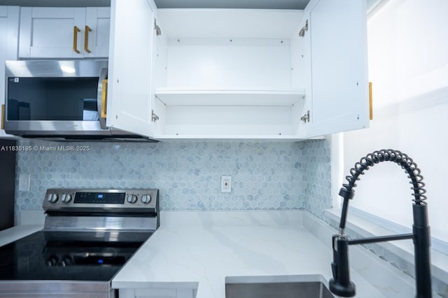2780 N Pine Island Rd Unit 211, Sunrise, FL 33322 - kitchen with stainless steel appliances, decorative backsplash, white cabinets, and light stone countertops