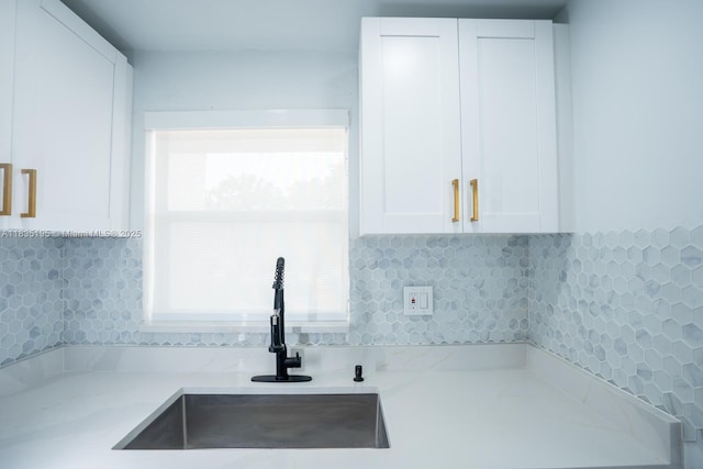 2780 N Pine Island Rd Unit 211, Sunrise, FL 33322 - kitchen with white cabinets, light stone counters, and backsplash