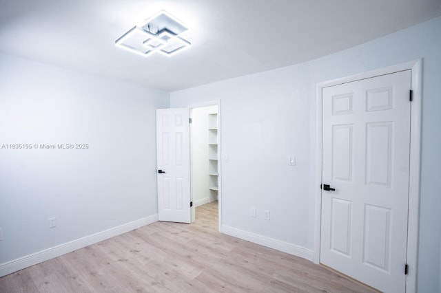 2780 N Pine Island Rd Unit 211, Sunrise, FL 33322 - unfurnished bedroom with light wood-style floors, a spacious closet, and a closet