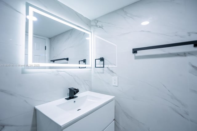 2780 N Pine Island Rd Unit 211, Sunrise, FL 33322 - bathroom featuring vanity and tile walls