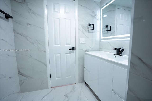 2780 N Pine Island Rd Unit 211, Sunrise, FL 33322 - bathroom with vanity, marble finish floors, and tile walls