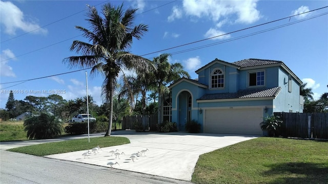 170 NE Dominican Ter, Port St Lucie, FL 34983 - mediterranean / spanish-style home with a tile roof, driveway, stucco siding, and an attached garage
