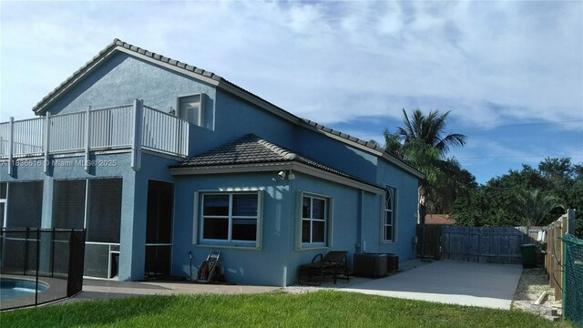 170 NE Dominican Ter, Port St Lucie, FL 34983 - rear view of house featuring stucco siding, a tile roof, and a patio
