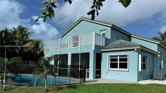 170 NE Dominican Ter, Port St Lucie, FL 34983 - rear view of property with a balcony, a tiled roof, stucco siding, and a patio