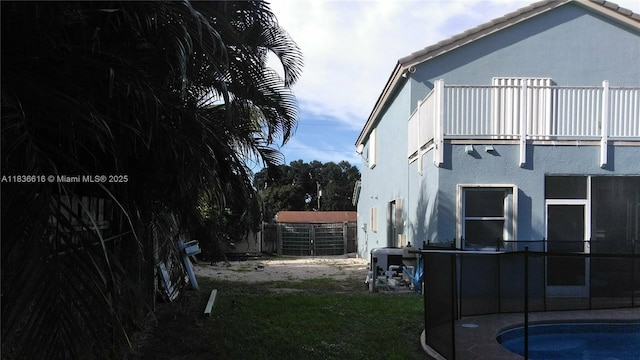 170 NE Dominican Ter, Port St Lucie, FL 34983 - rear view of house featuring a balcony and stucco siding