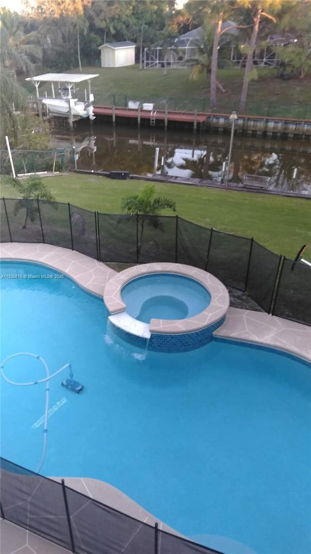 170 NE Dominican Ter, Port St Lucie, FL 34983 - view of swimming pool with a water view and a pool with connected hot tub