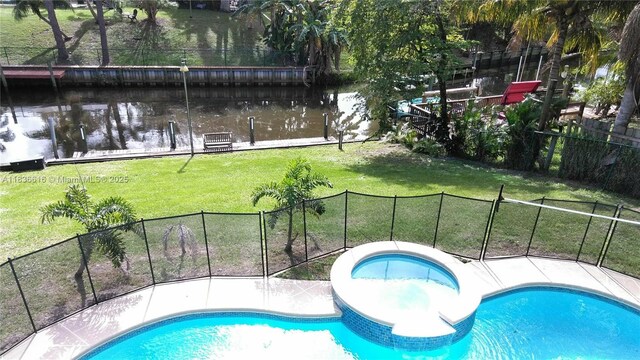 170 NE Dominican Ter, Port St Lucie, FL 34983 - view of swimming pool with a water view and a pool with connected hot tub