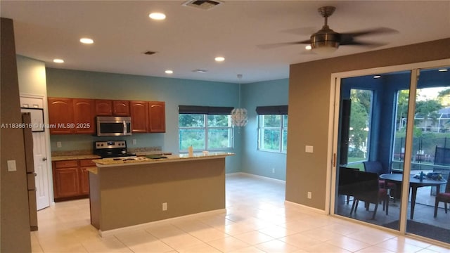 170 NE Dominican Ter, Port St Lucie, FL 34983 - kitchen featuring stainless steel appliances, recessed lighting, a center island, ceiling fan, and light countertops