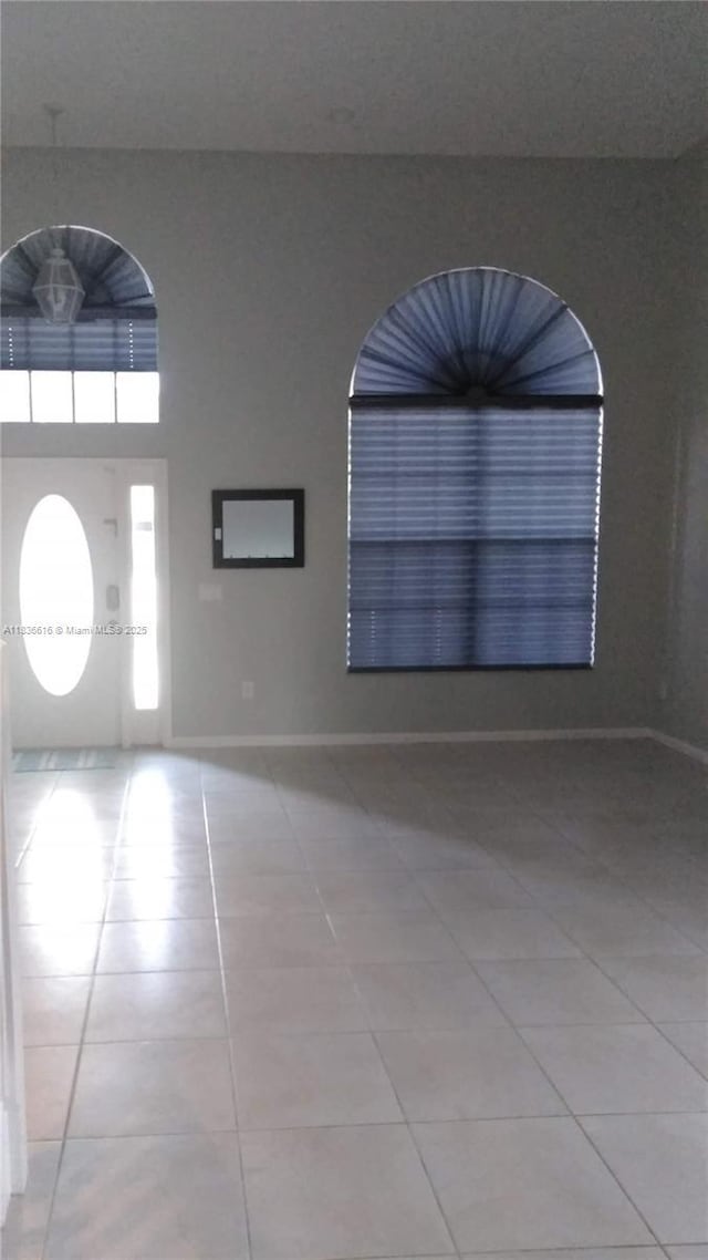 170 NE Dominican Ter, Port St Lucie, FL 34983 - entryway featuring tile patterned floors and baseboards
