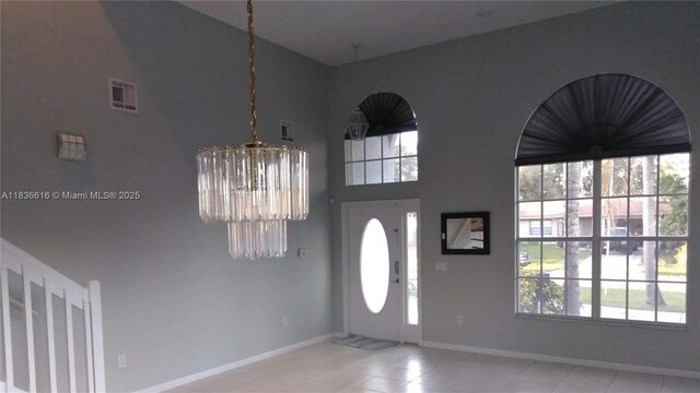 170 NE Dominican Ter, Port St Lucie, FL 34983 - tiled foyer featuring a chandelier and a high ceiling