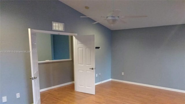 170 NE Dominican Ter, Port St Lucie, FL 34983 - spare room featuring ceiling fan, wood finished floors, and high vaulted ceiling