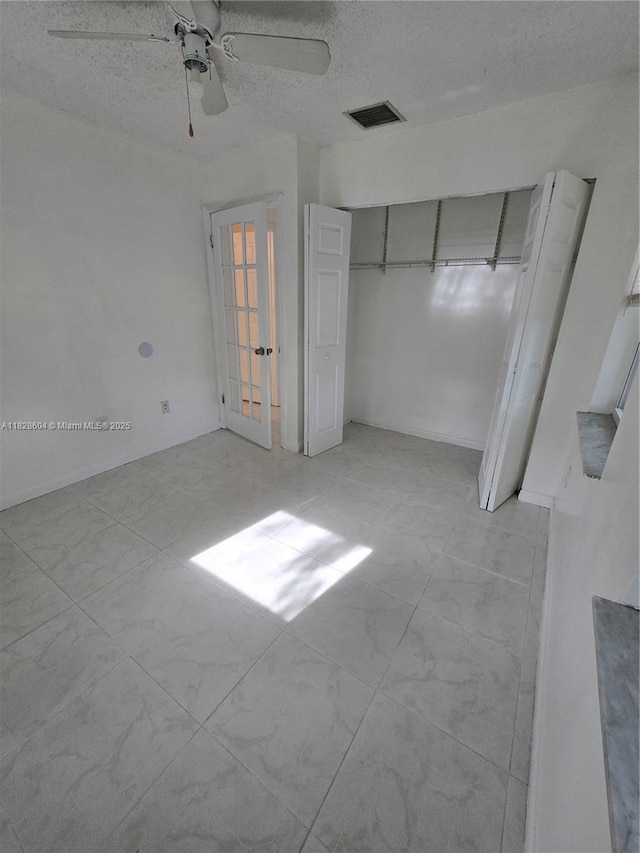 13567 SW 286th Ter, Homestead, FL 33033 - unfurnished bedroom with a textured ceiling, ceiling fan, and a closet