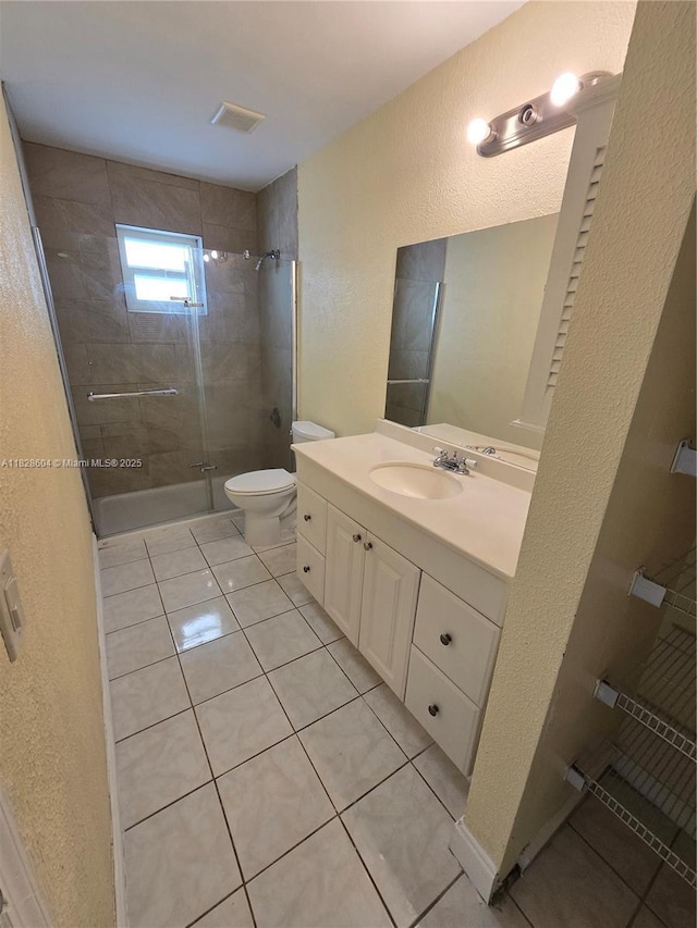 13567 SW 286th Ter, Homestead, FL 33033 - bathroom featuring a textured wall, a stall shower, vanity, and tile patterned floors