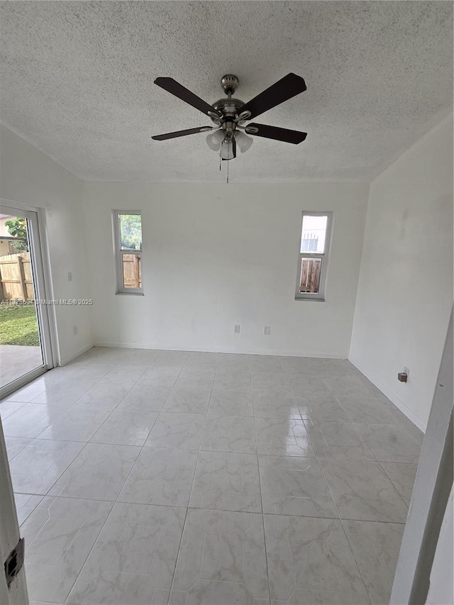 13567 SW 286th Ter, Homestead, FL 33033 - spare room featuring plenty of natural light, a ceiling fan, and a textured ceiling