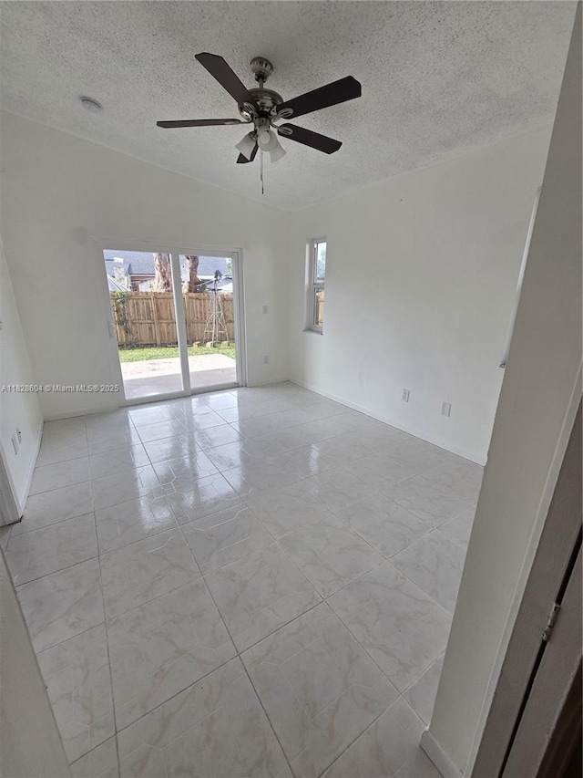 13567 SW 286th Ter, Homestead, FL 33033 - empty room featuring healthy amount of natural light, a textured ceiling, ceiling fan, and marble finish flooring