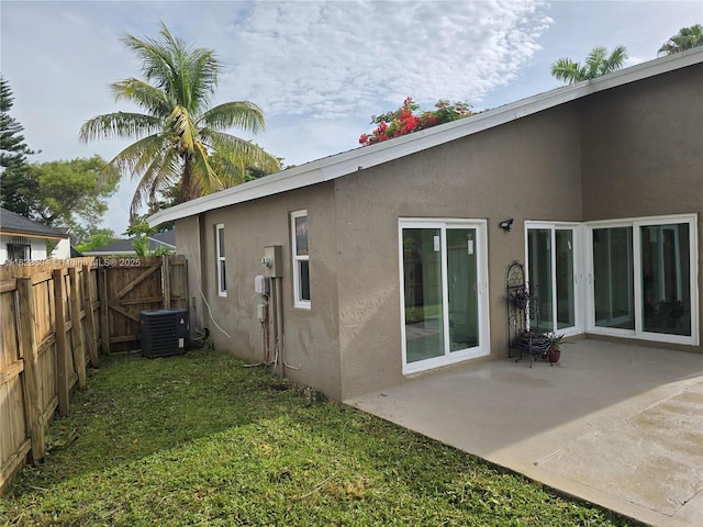 13567 SW 286th Ter, Homestead, FL 33033 - back of house featuring stucco siding and a patio area