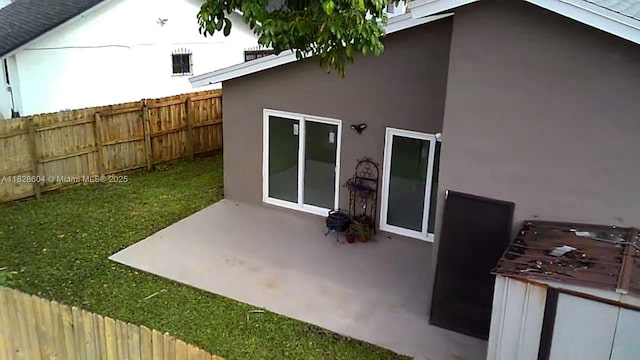 13567 SW 286th Ter, Homestead, FL 33033 - back of property with stucco siding and a patio area