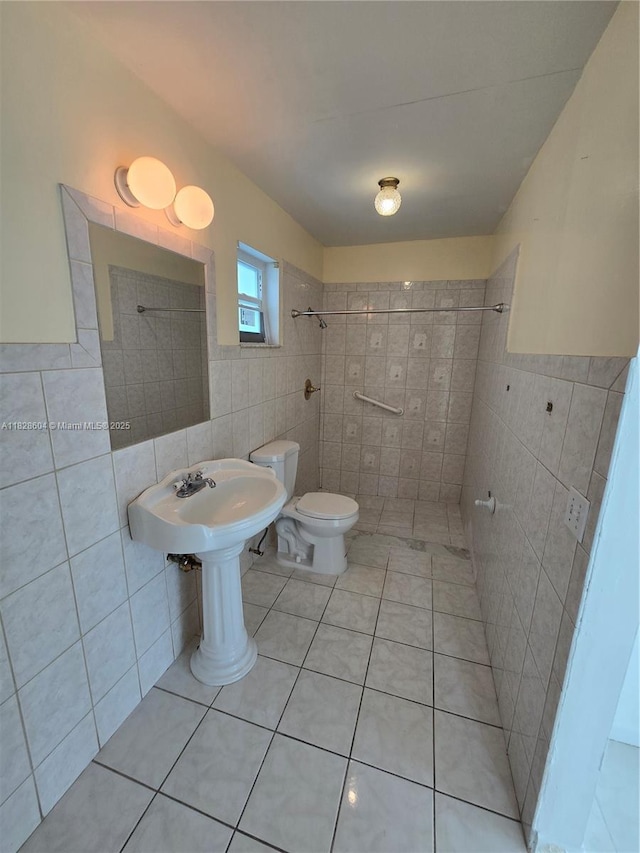 13567 SW 286th Ter, Homestead, FL 33033 - bathroom with tile walls, a tile shower, tile patterned floors, and a wainscoted wall