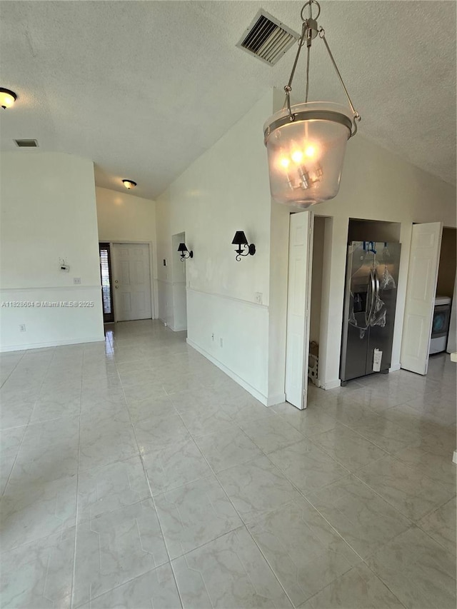 13567 SW 286th Ter, Homestead, FL 33033 - unfurnished living room featuring vaulted ceiling and a textured ceiling